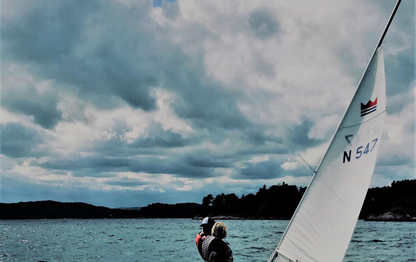 Two people sailing in a small sporty sailing boat