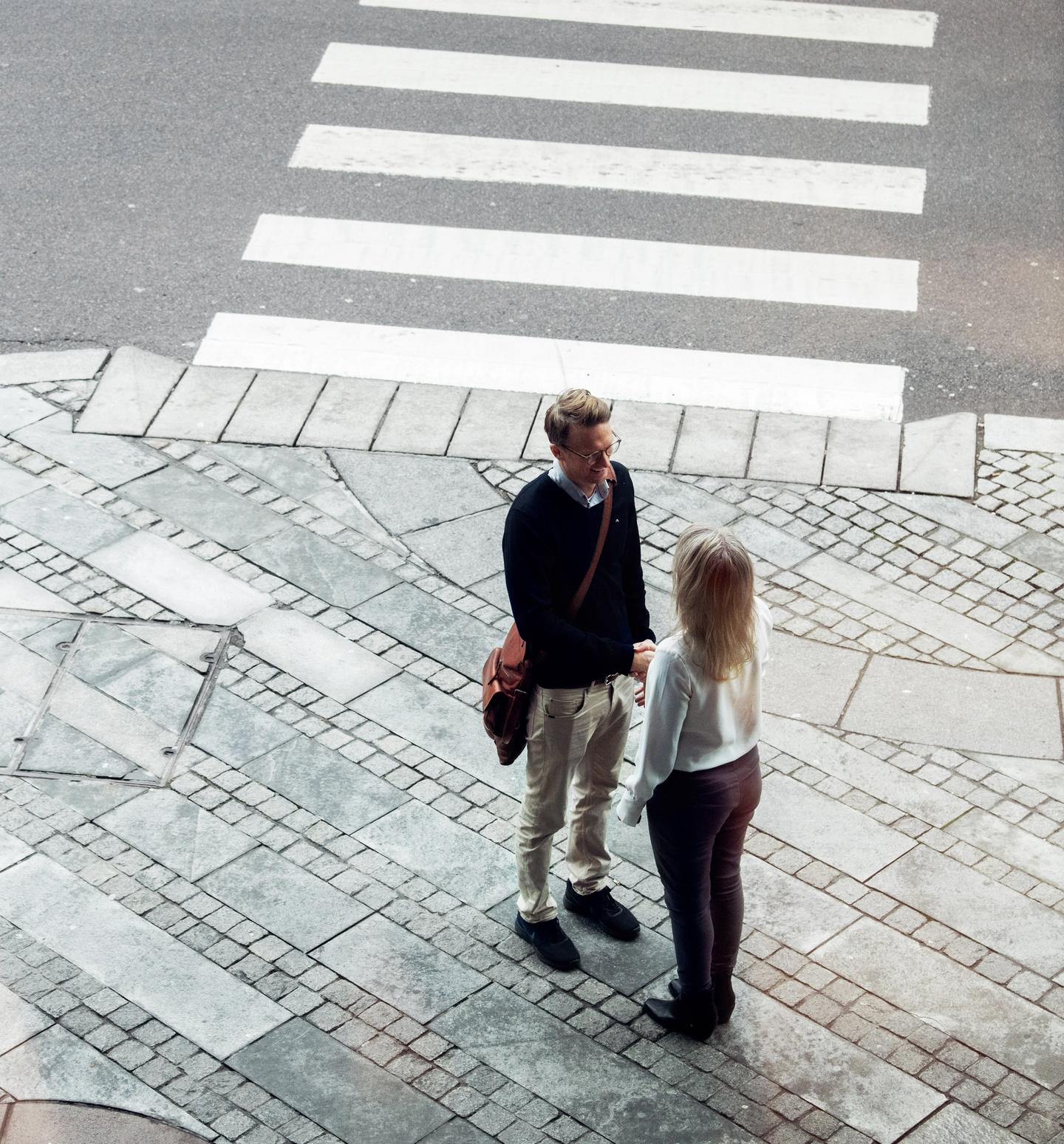 Two people talking on the street